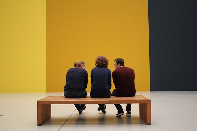 three people in a gallery